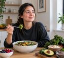 Young woman enjoying a fiber-rich salad with fresh fruits and vegetables.
